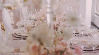 Parralax shot of beautifully served wedding table with flowers and candelabras