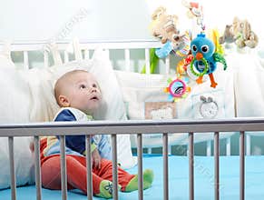 Baby learning through senses in cot