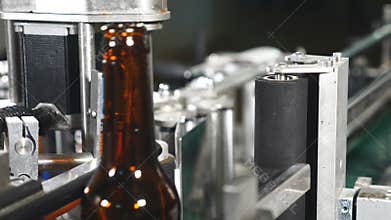 Food industry. Automatic Beer Bottling Line. Applying the label. Machine for pasting labels for beer bottles. Empty