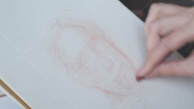 Artist sketching model face using crayon at cafe