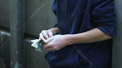 Teenage child counting pocket money, social assistance to orphan, poverty