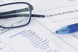 Calculation document with pen and eyeglasses