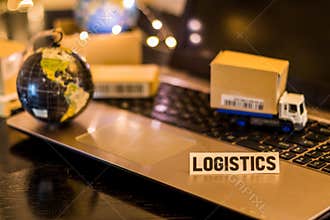 Logistics Supply Chain Challenges - still life logistics business concept with laptop, phone, mini shipping cartons