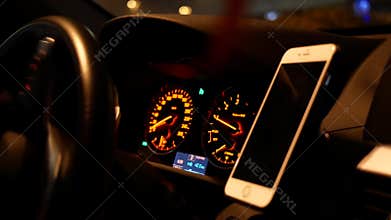 Motion of car driving and focusing on car dashboard at night