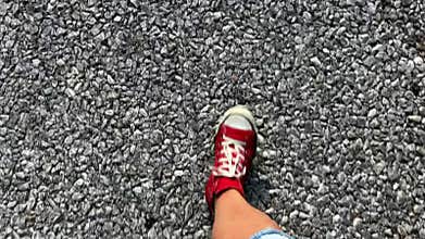 Closeup steps on the road in red shoes