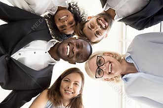 Happy diverse business team gathering in circle looking at camer