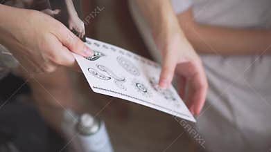Fees and preparation for a photo shoot, the choice of a tattoo design, no faces, only hands show pictures of the future