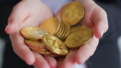 Crop businesswoman holding bitcoins