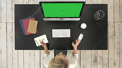 Person Doing Video Conference on Computer. Green Screen Mock-up Display.