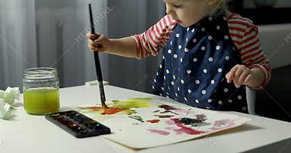 Child painting with watercolors