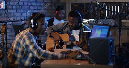 Young musicians playing in home studio