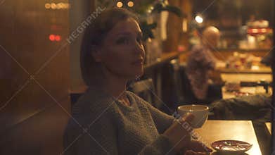 Female writer looking at christmas decorations of city, magic moment inspiration