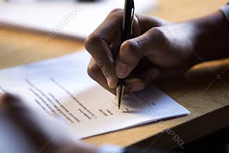 Male african hand write signature on legal corporate paper docum