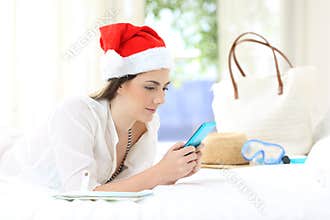 Woman using a smart phone on christmas holidays