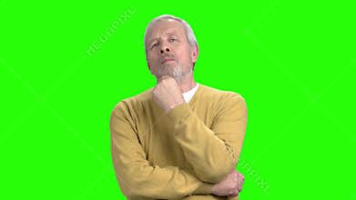 Thoughtful mature man on green screen.