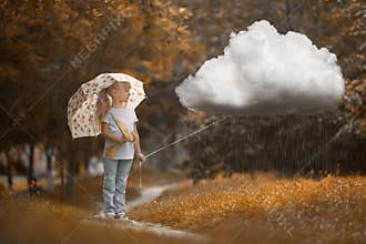 A girl walking the rainy cloud at autumn time on the orange background