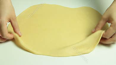 Cooking and stretching dough with rolling pin