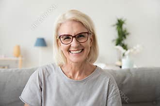 Smiling middle aged mature grey haired woman looking at camera
