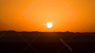 Time lapse of sunrise in desert over sand dunes or plateau. Dawn in UAE, sunup, rising of the sun, morning in desert