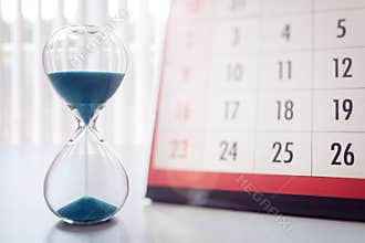 Hour glass and calendar important appointment date, schedule and deadline