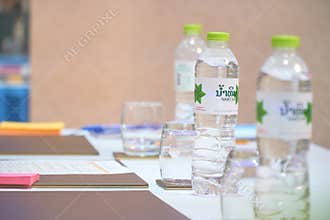 Vientiane Capital, Laos - April 05, 2019: The Water Bottles on the Table with Glasses and Colorful Paper Notes in the Meeting Room
