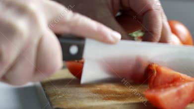 Close Up Of Man Slicing Tomatoes With Knife