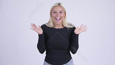Young happy blonde woman looking surprised