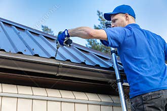 Metal roofing - roofer working on the house roof