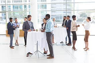 Business people interacting with each other at table during a seminar