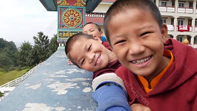BHAKTAPUR, KATHMANDU, NEPAL - 18 October 2018 Laughing ethnic boys of monastery smiling at camera. Asian boys smiling