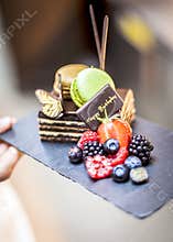 Happy birthday cake with fresh fruits and macaroons