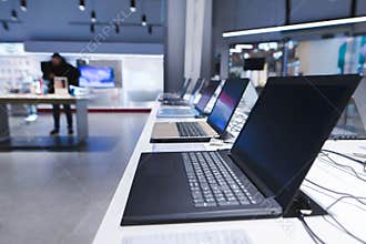 Laptops on the table in the electronics store. The department of laptops in the tech store. Buy a laptop
