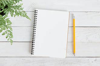 Blank notebook with and pencil on white wood,Flat lay photo of notebook for your message