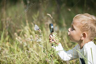 Young researcher explores nature with a magnifying glass