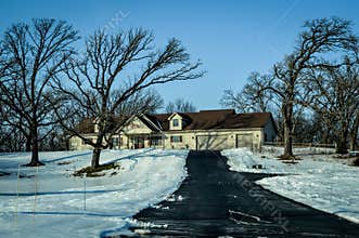 Ranch House with Long Driveway in Winter