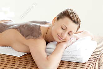 Portrait of a bright woman enjoying a mud skin tre