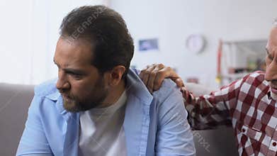 Wise father supporting his lost in life son, giving advices, middle age crisis