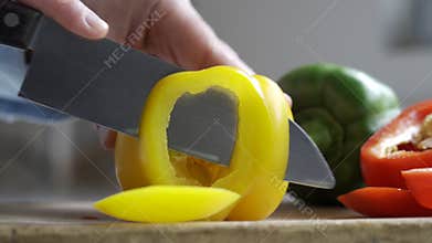 Close up of man slicing yellow pepper