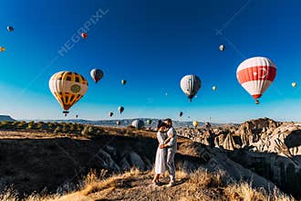 Wedding travel. Honeymoon trip. Couple in love among balloons. A guy proposes to a girl. Couple in love in Cappadocia. Couple in