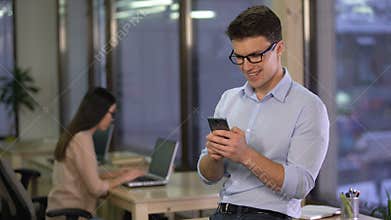 Office employee chatting in social media messenger on smartphone, communication