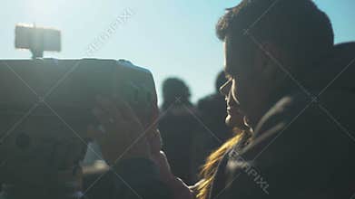 Man and lady looking to tower viewer on skydeck, enjoying beautiful city scenery