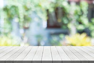 White wood table top on nature green blurred background for montage your product