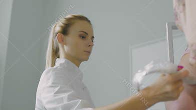 The doctor does ultrasound examination of the legs in the patient.