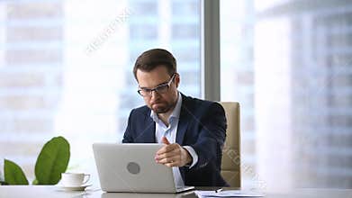 Angry frustrated businessman mad about computer problem virus at work