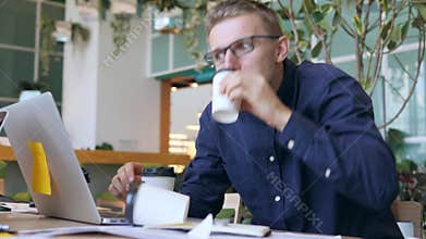 Funny Crazy Programmer with Caffeine Addiction Drinking Coffee and Typing Fast on Laptop in the Office. 4K.