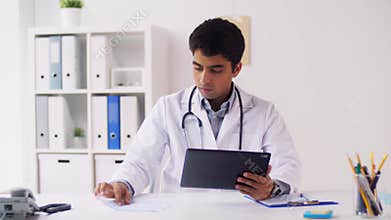 Doctor with tablet pc and papers at hospital