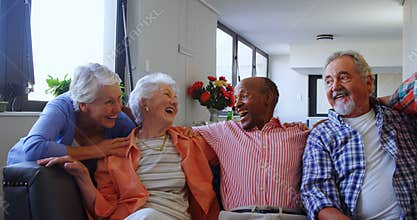 Happy senior friends having fun while relaxing on sofa 4k