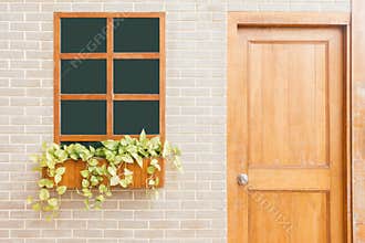 Wooden front door of a home. Front view of a wooden front door on a yellow house.