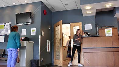 Motion of medical assistant calling patient to take xray