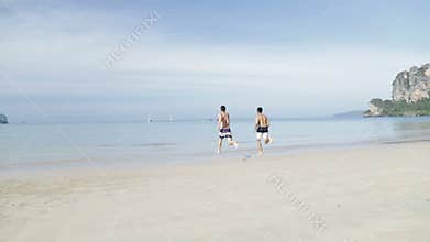 Two Man Running In Water On Beach, Young Male Couple On Sea Vacation Tourists